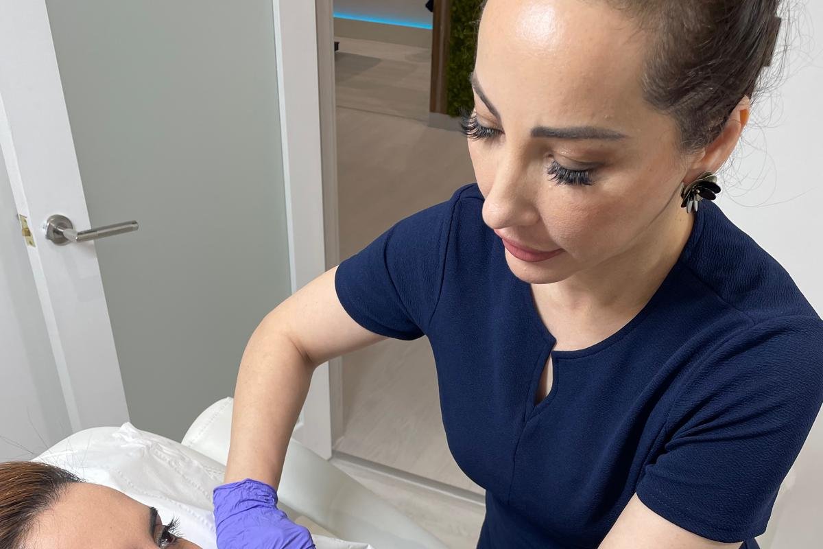 Trained practitioner carrying out a safe lip filler treatment at a GPhC-registered clinic in Bury, Greater Manchester